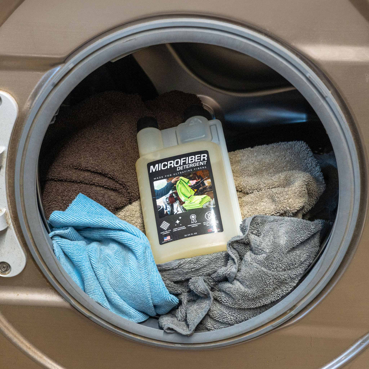 Microfiber detergent bottle in a washing machine with towels in a laundry room setting