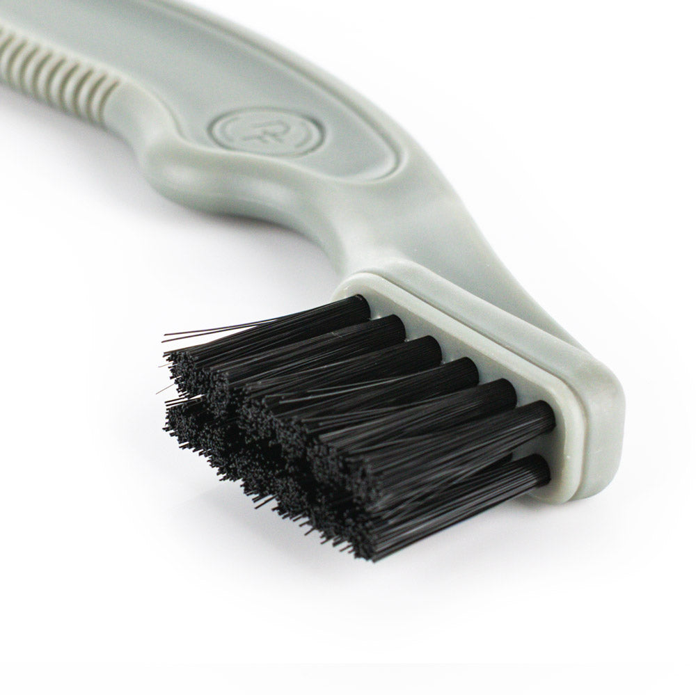 Cleaning brush with black bristles on a white background