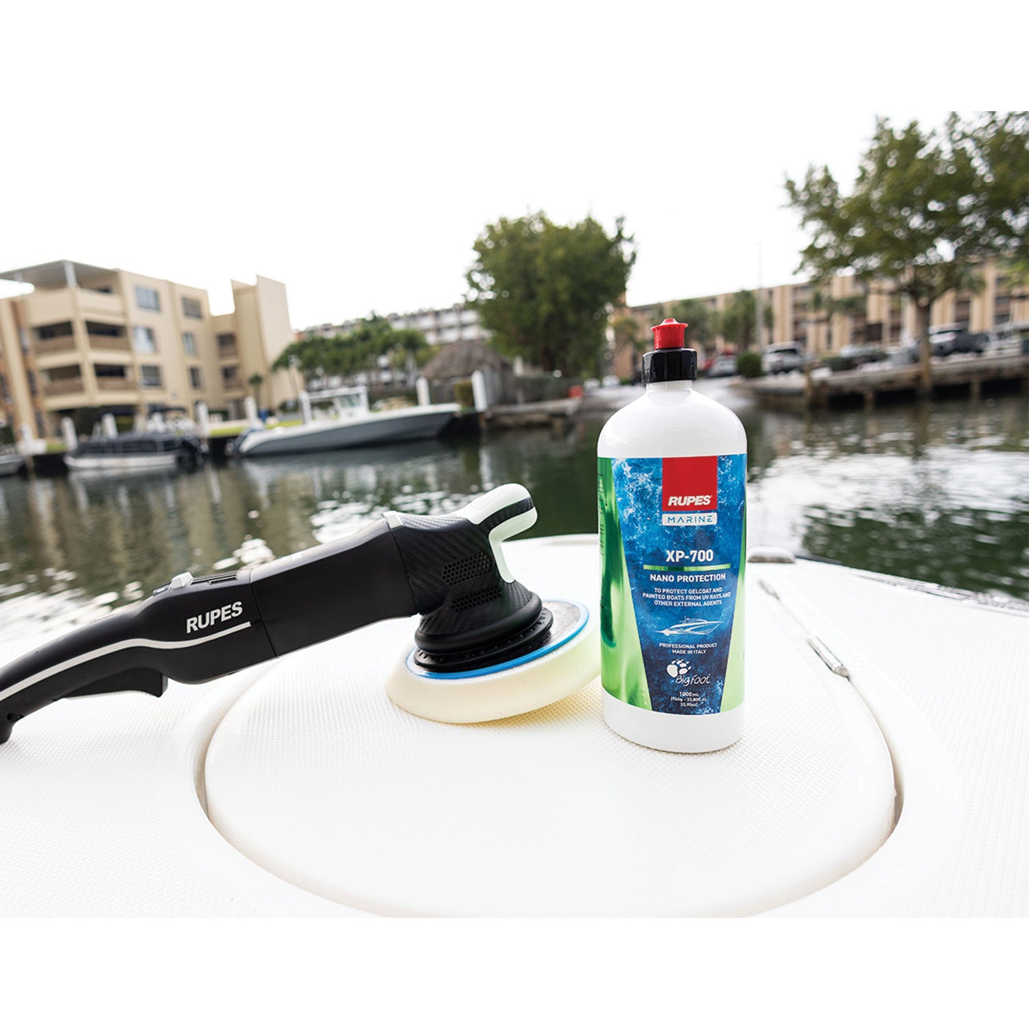 Rupes polisher and bottle of XP-700 car care product on a boat with a marina background