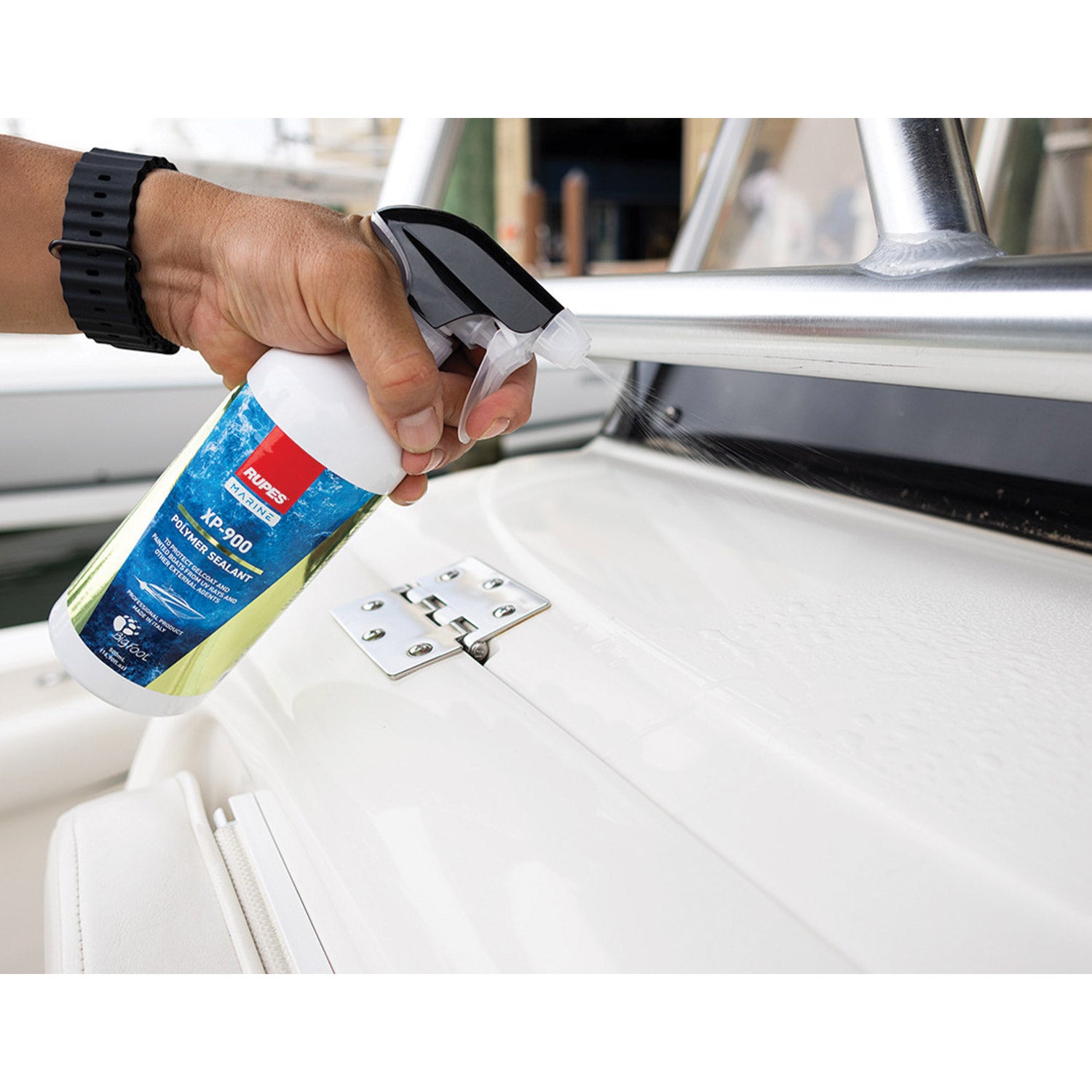 Spraying RUPES XP-900 polymer sealant on a boat in the marina