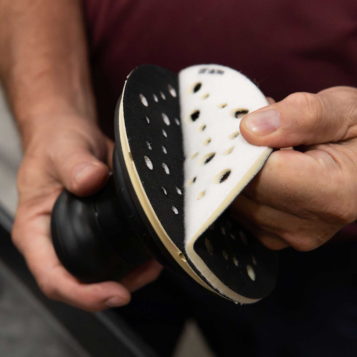 Peeling a RUPES foam interface pad off the hook and loop backing plate