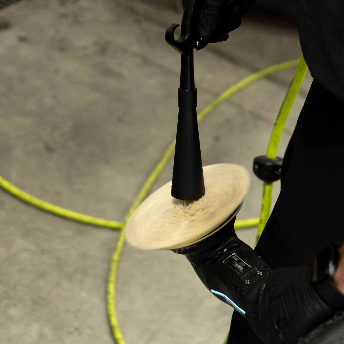 Stinger Twister Blow Gun cleaning a polishing pad on a polisher with compressed air