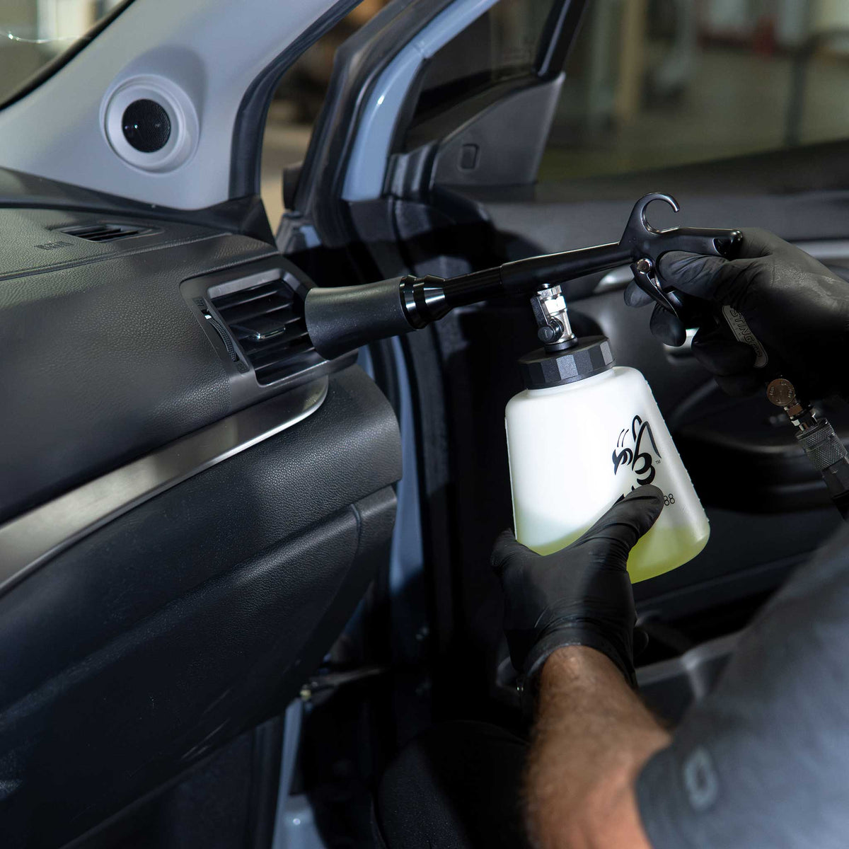 Stinger Twister Complete tool cleaning dash vents and door panel vinyl with green cleaner