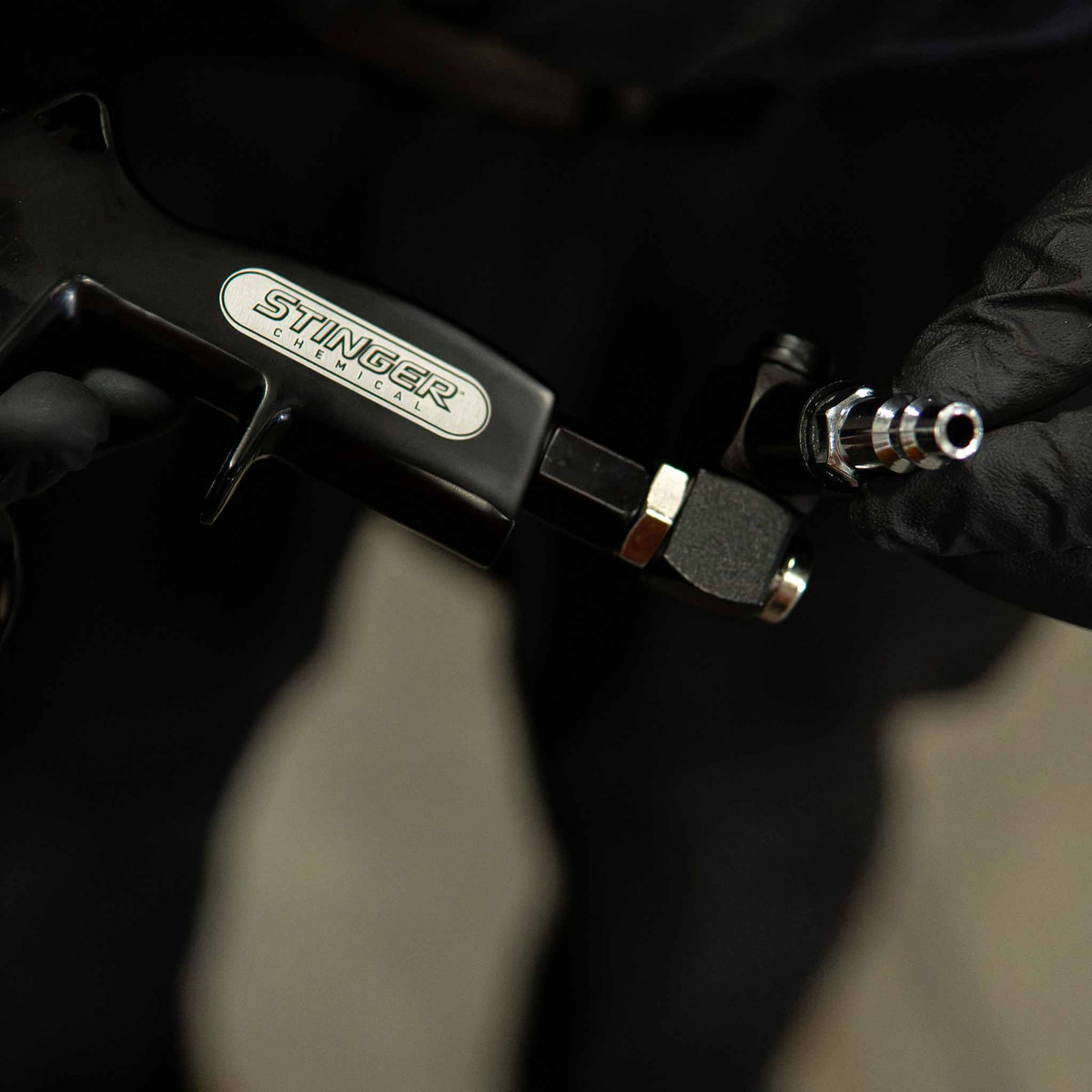 Stinger Twister 90 degree swivel adapter installed on a blow gun with a quick connect plug