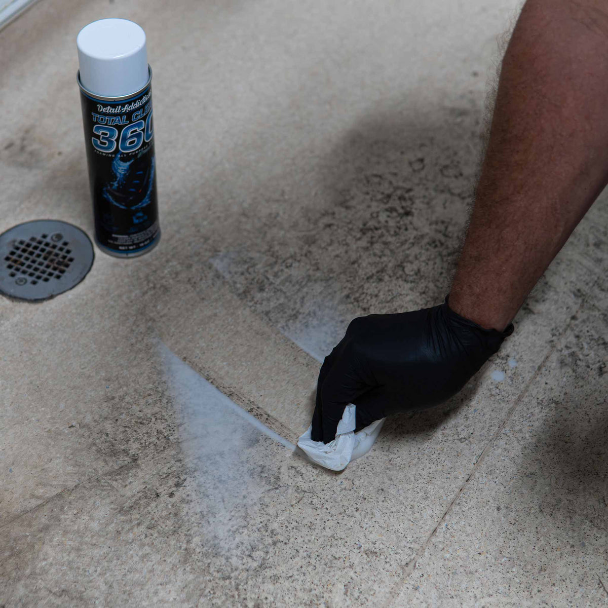 Detail Addictions Total Clean 360 wiped off a grimy bathroom floor with a towel, leaving a clean streak