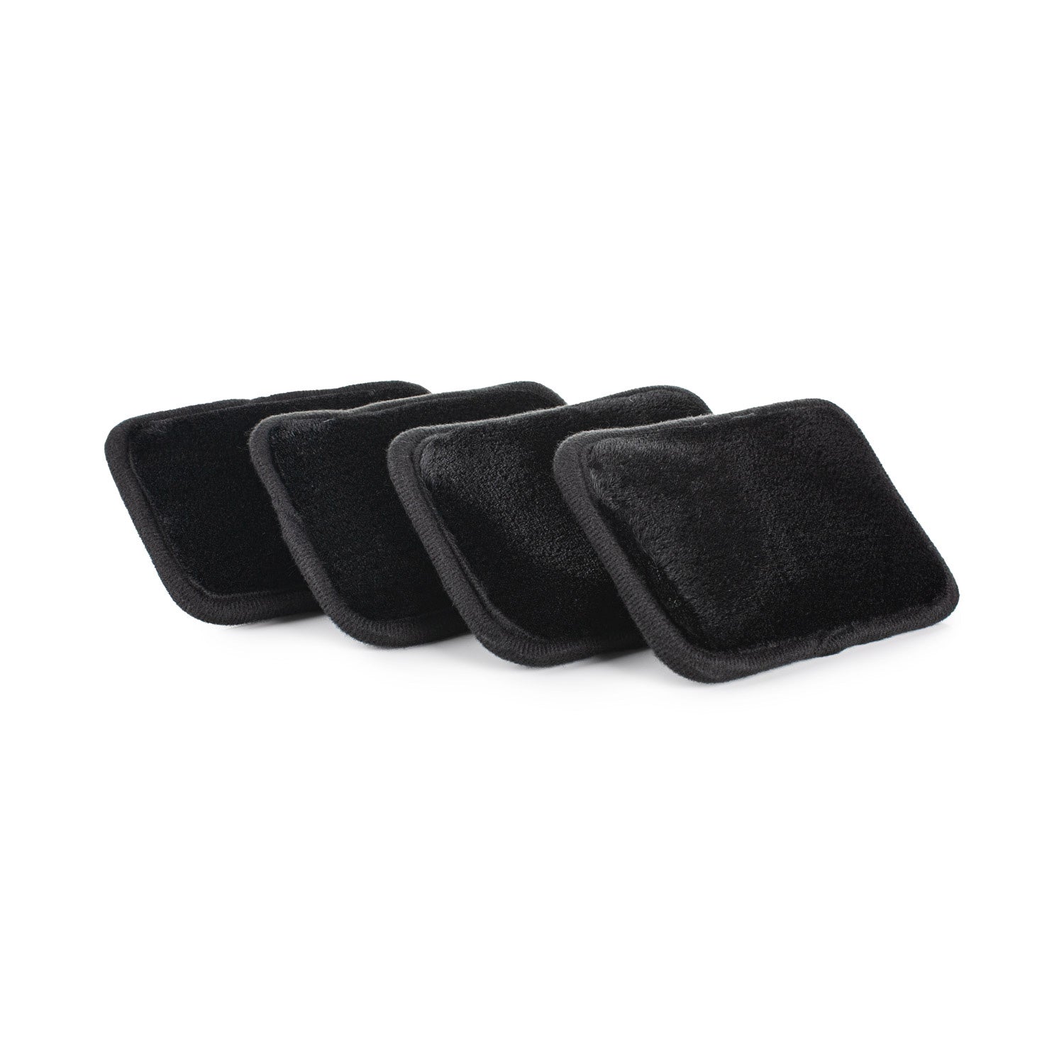 Four black square interior scrubbers on a white background