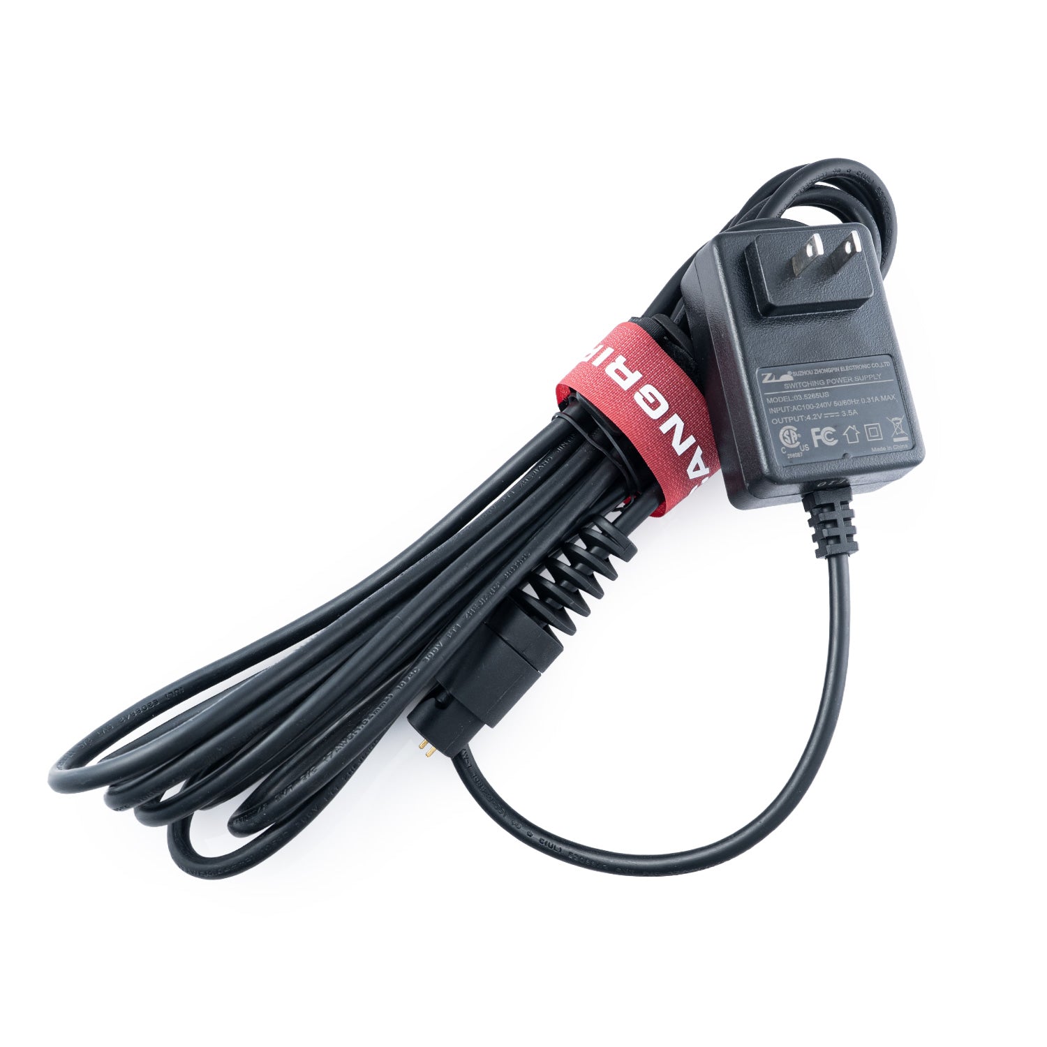 Scangrip Power adapter with a coiled black cable on a white background